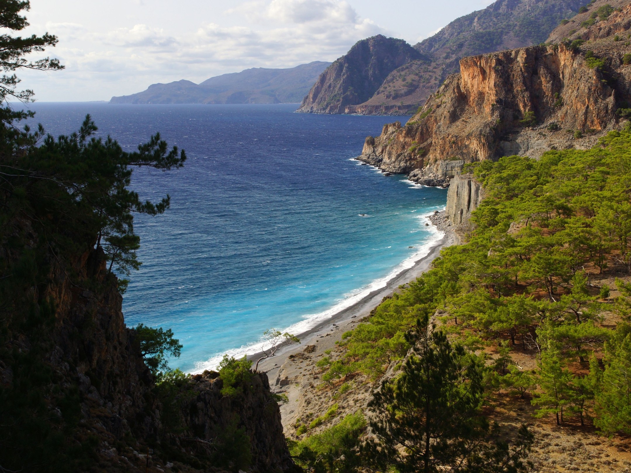 a body of water with a mountain in the background