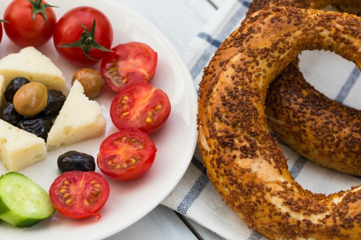 a plate of food with a slice of fresh fruit