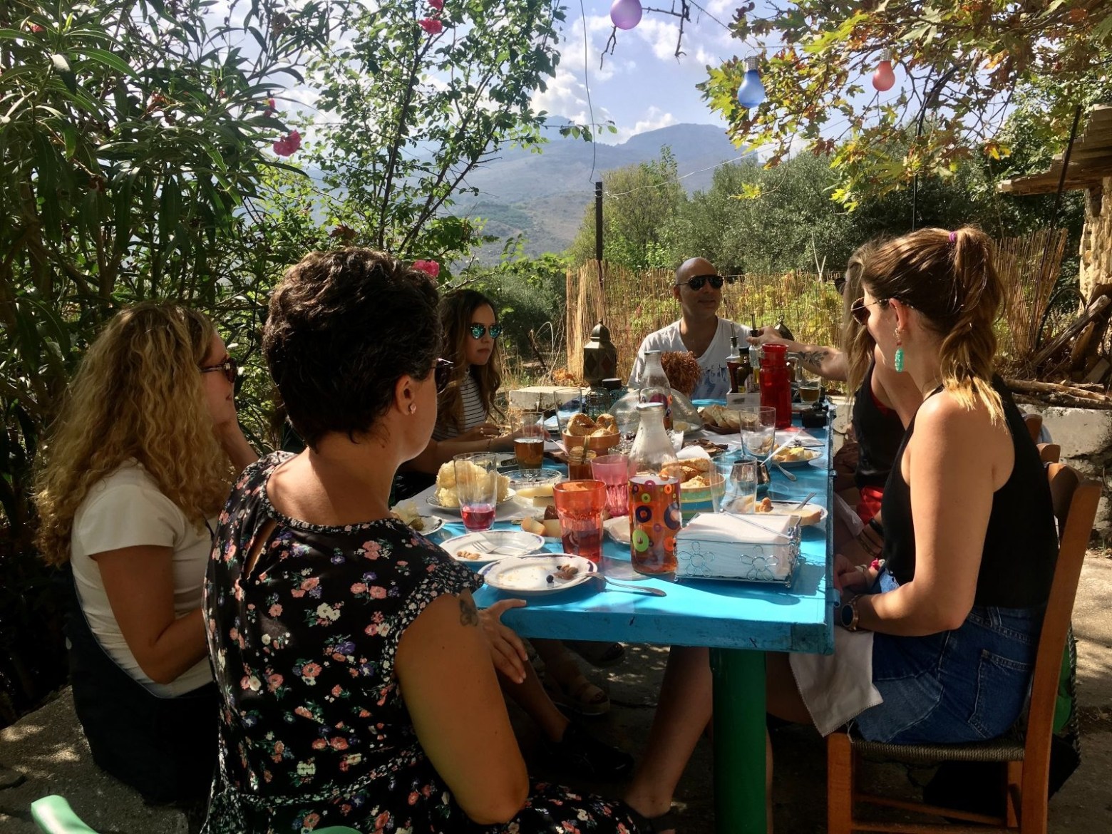 a group of people sitting at a picnic table