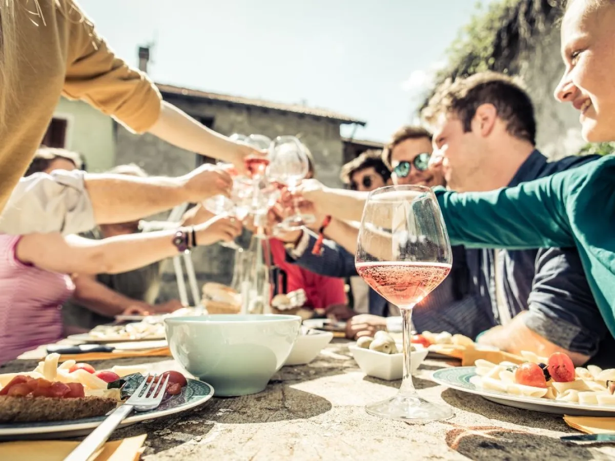 a group of people sitting at a table with a plate of food