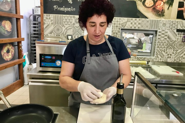 a woman cooking food in a kitchen