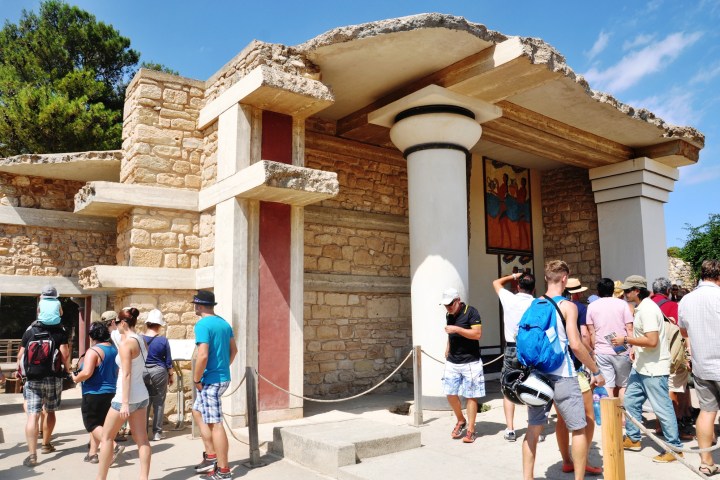 a group of people walking in front of Knossos